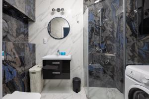 y baño con ducha, lavabo y aseo. en Flaminga Two-Level Apartment, en Szczecin