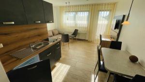 a kitchen with a sink and a table in a room at Ferienwohnung-Ostseestrand in Graal-Müritz