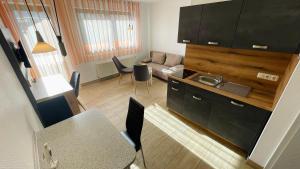 a kitchen and living room with a couch and a table at Ferienwohnung-Ostseestrand in Graal-Müritz