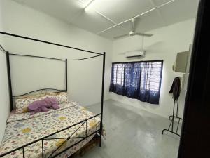 a bedroom with a bed with a glass canopy at RumaDino Homestay in Melaka