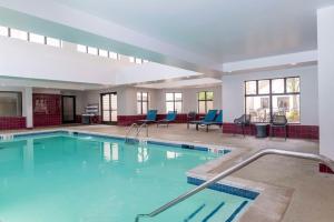 a large swimming pool with blue chairs in a building at Hampton Inn & Suites St. Louis-Chesterfield in Chesterfield