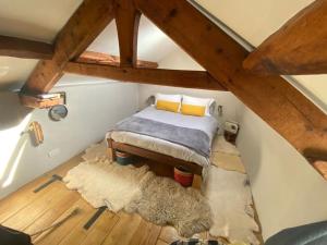 a attic room with a bed and a rug at Cartmel Barn: Beckside Stables in Cartmel