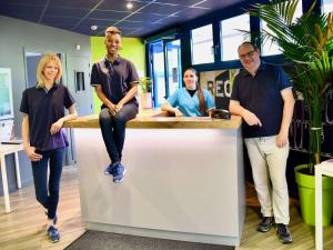 four people standing around a counter in an office at ibis budget Cholet Centre in Cholet