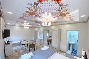 a large room with a ceiling with a chandelier at NANOSH EAST HOTEL in Bukhara