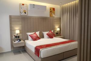 a bedroom with a large bed with red pillows at فيرانو - Virano in Riyadh +74 photos