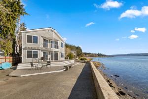 a house on the shore of a body of water at Belfair Beach House in Belfair
