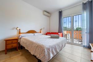 a bedroom with a bed with a laptop on it at Villa Alpamar in Les tres Cales +29 photos