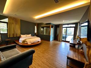 a bedroom with a bed and a living room at House of Ahan in Meishan
