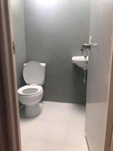 a bathroom with a toilet and a sink at Payag in El Nido