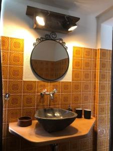 a bathroom with a sink and a mirror at Ferienhaus Bergträumli (Keine direkte Zufahrt) in Gommiswald