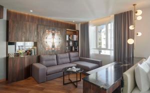 a living room with a couch and a table at Hyatt Centric Gran Via Madrid in Madrid