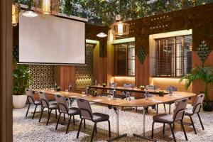 a conference room with a large wooden table and chairs at Hyatt Centric Gran Via Madrid in Madrid