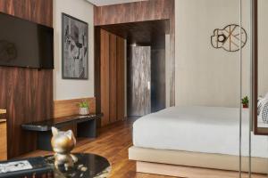 a bedroom with a bed and a table at Hyatt Centric Gran Via Madrid in Madrid