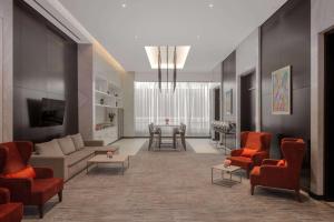 a living room with a couch and chairs and a table at Hyatt Place Riyadh Sulaimania in Riyadh