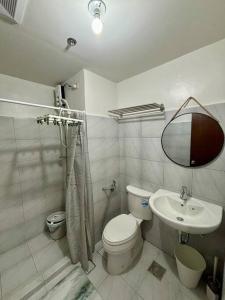 a bathroom with a toilet and a sink at Casa Mira Guadalupe by Leera's Condo in Cebu City