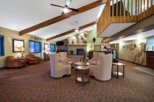 a lobby with chairs and a table and a living room at AmericInn by Wyndham Ashland in Ashland