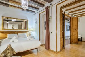 a bedroom with a white bed and a mirror at Encanto en Las Ramblas: Espacio perfecto para 9 in Barcelona