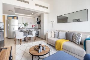 a living room with a couch and a table at Frank Porter - The Nook 2 in Dubai