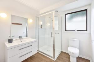 a white bathroom with a toilet and a shower at Jamieson Cottages - Cottage 1 in Howqua