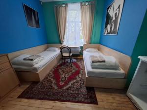 a room with two beds and a window at Jamaika @ Shopen in Vilnius +35 photos