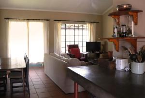 a living room with a couch and a table at Schaefers' Halt in Dullstroom