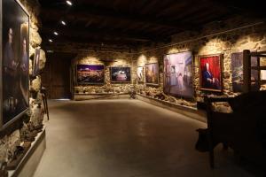 a room with paintings on the walls of a museum at Casa-Museo Genia Trigo in Sober