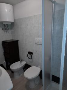 a bathroom with a toilet and a sink and a shower at BBrezza Marina in Stintino