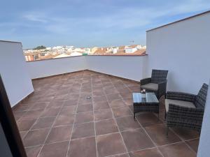 a room with two chairs and a table on a balcony at Apartamentos Antequera in Antequera