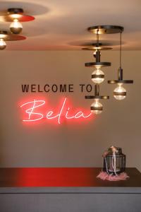 a welcome to belgium neon sign on a wall at Belia Lofts - ADULTS ONLY - Apartments in Appiano sulla Strada del Vino