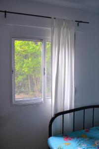a bedroom with a window and a bed in front of it at Heavenly place in Possidi