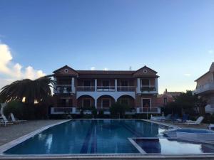 a large swimming pool in front of a house at Angela Corfu in Corfu Town