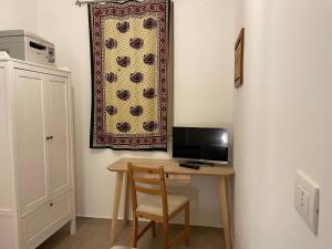 a room with a desk with a computer and a curtain at VILLA DALU not only Holidays in Trani