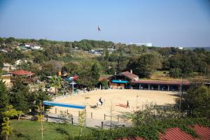 a playground in a park with people playing in the sand at MAVİ AT HOTEL Blue Horse in Gümüşdere