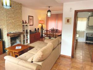 a living room with a couch and a fireplace at Casa Gracia Málaga Corazón de Andalucía in Fuente de Piedra