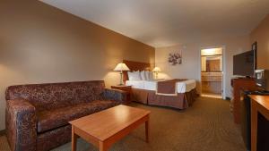 a hotel room with a bed and a couch at Quality Inn & Suites in Williamsport