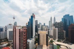 a view of a city skyline with tall buildings at Luxury 2BR Designer Suite above Pavilion Mall in Kuala Lumpur