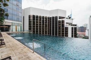 a swimming pool on the roof of a building at Luxury 2BR Designer Suite above Pavilion Mall in Kuala Lumpur
