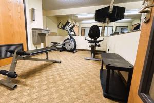 a room with a gym with two exercise bikes at Howard Johnson by Wyndham Urbana in Champaign