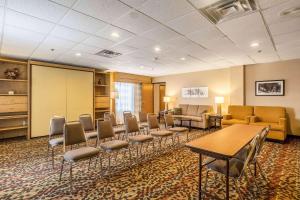 a waiting room with chairs and a table in a room at Wingate by Wyndham Owensboro in Owensboro