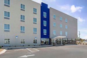 a large building with a parking lot in front of it at Sleep Inn & Suites in Fort Walton Beach