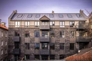 a large brick building with a metal roof at Luxurious Hideaway in Centrum in Bergen