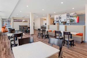 a restaurant with tables and chairs and a bar at Sleep Inn & Suites in Fort Walton Beach
