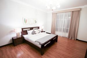 a bedroom with a large bed and a window at Aman Plaza in Juffair