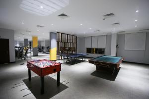 a room with two ping pong tables in it at Aman Plaza in Juffair