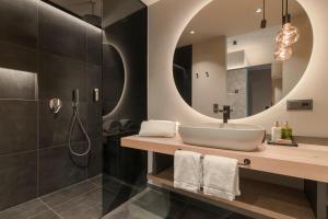 a bathroom with a sink and a mirror at Belia Lofts - ADULTS ONLY - Apartments in Appiano sulla Strada del Vino