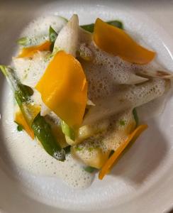 a white plate of food with vegetables on it at Hostel Balingen in Balingen