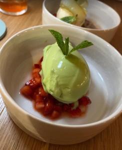 a white bowl with ice cream on top of food at Hostel Balingen in Balingen