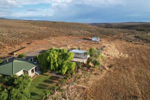 an aerial view of a house in the middle of a field at Middelfontein Farm in Sutherland
