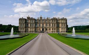 a large castle with two fountains in front of it at Country View Camping in Bratton