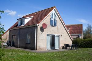 a brick house with a table in front of it at Kustverhuur, Park Scheldeveste Zwin 065 in Breskens